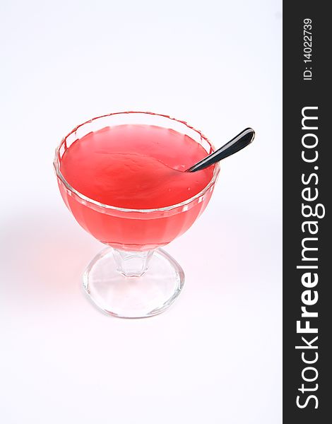 Strawberry fruit cream in a glass cup with a spoon