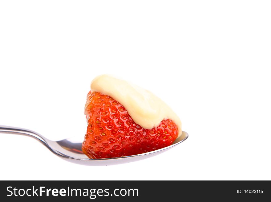 Strawberry with vanilla pudding on a spoon isolated