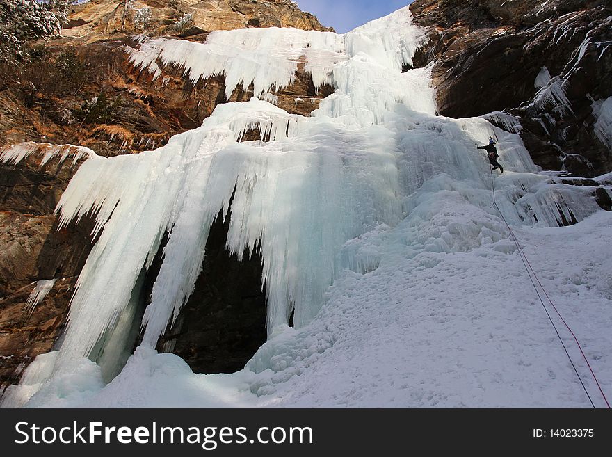 Huge icefall with small iceclimber