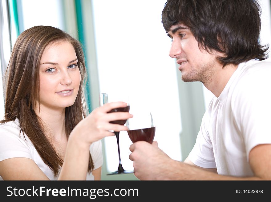 Long-haired girl with smile and boy with wineglasses. Long-haired girl with smile and boy with wineglasses