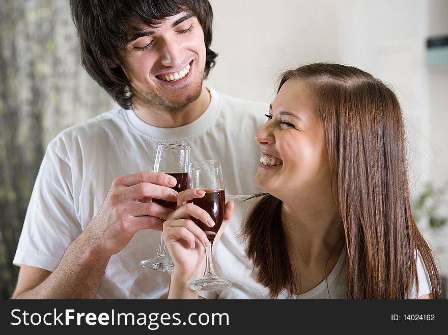 Nice girl with smile and boy with wineglasses. Nice girl with smile and boy with wineglasses