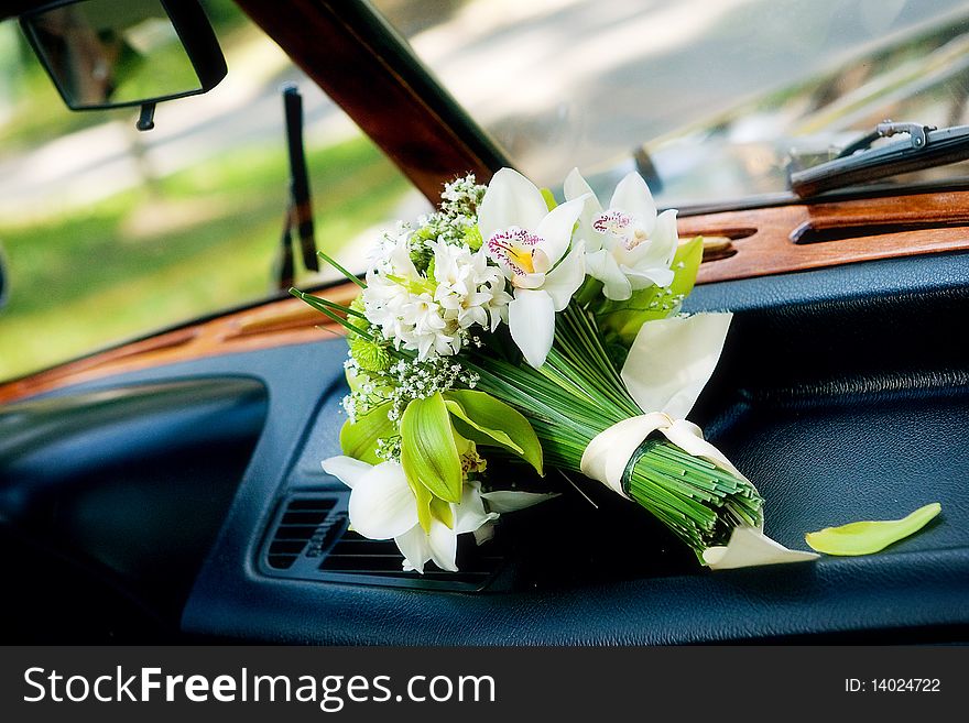 Bridal bouquet on wedding day in car