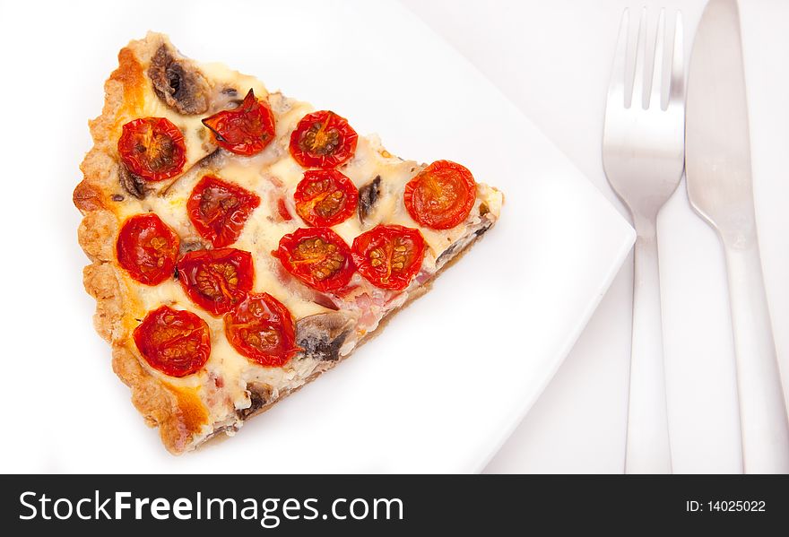 Piece of tomato tart with tableware