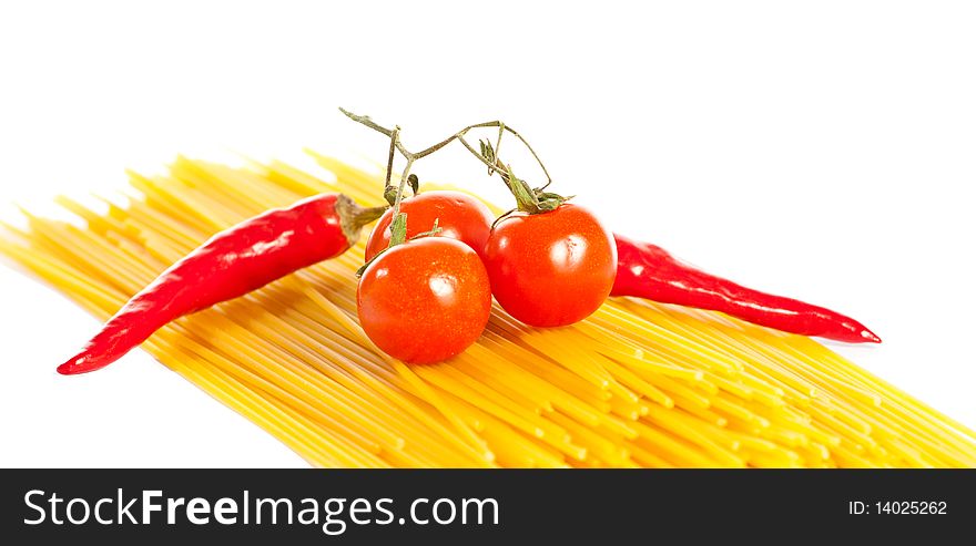 Red hot chilli peppers, tomatoes and pasta isolated on white