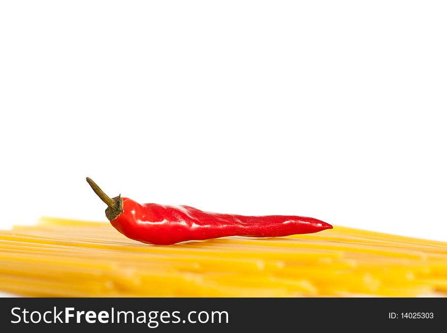 Red hot chilli peppers and pasta isolated on white