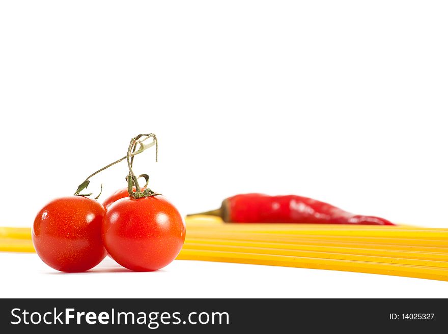 Red hot chilli peppers, tomatoes and pasta isolated on white