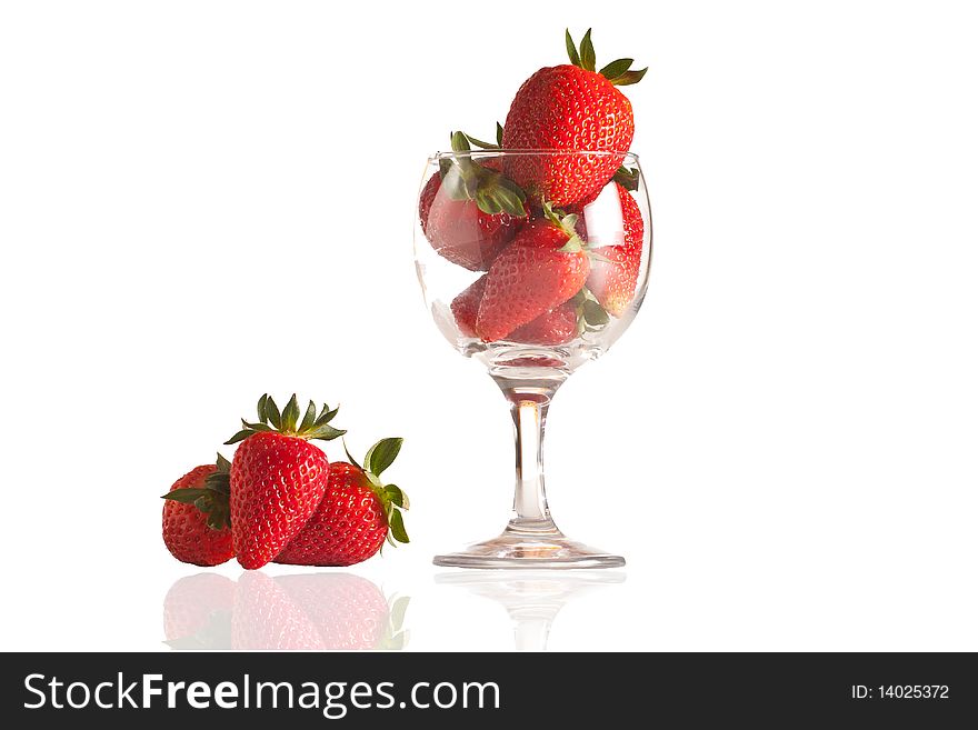 Fresh strawberries in a glass on white background