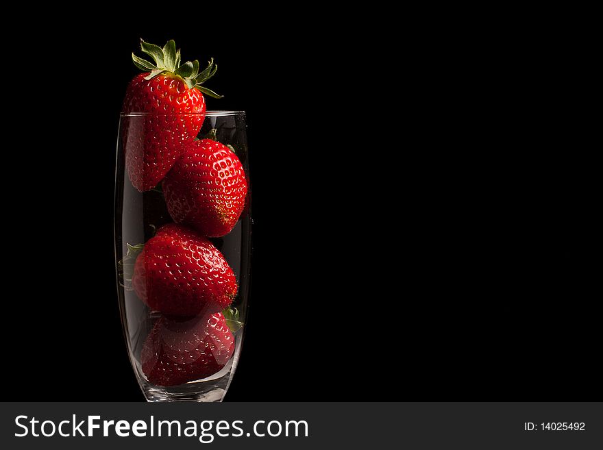 Fresh Strawberries in a glass on black background