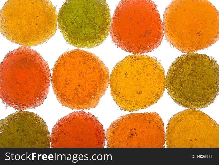 Background of green, yellow, orange and red fruit candyes isolated on white. Background of green, yellow, orange and red fruit candyes isolated on white