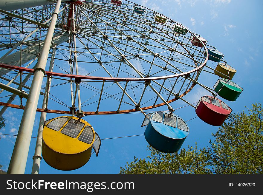 A colourful ferris-wheel at park. A colourful ferris-wheel at park