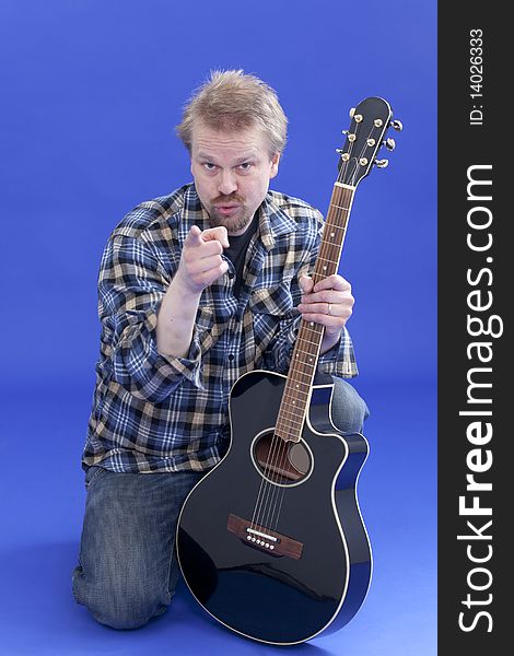 Studio portrait of a man posing with guitar. Studio portrait of a man posing with guitar.