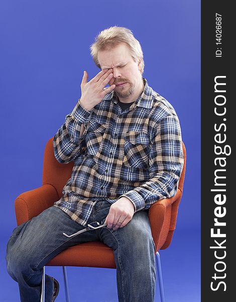 Tired Man Sitting On A Chair