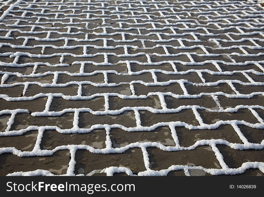 Snow texture on paving slab in winter