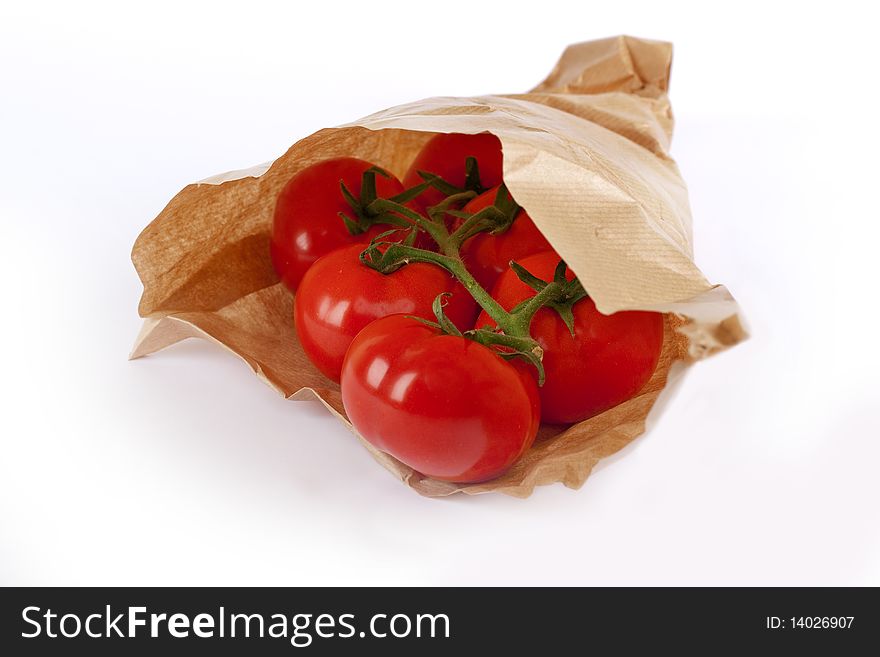 Tomatoes in paper bag, fresh vegetable at the market