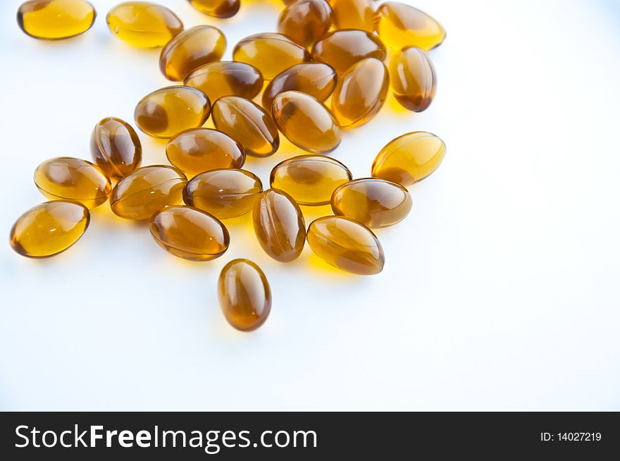 A cluster of rice oil capsules isolated against a white background. A cluster of rice oil capsules isolated against a white background