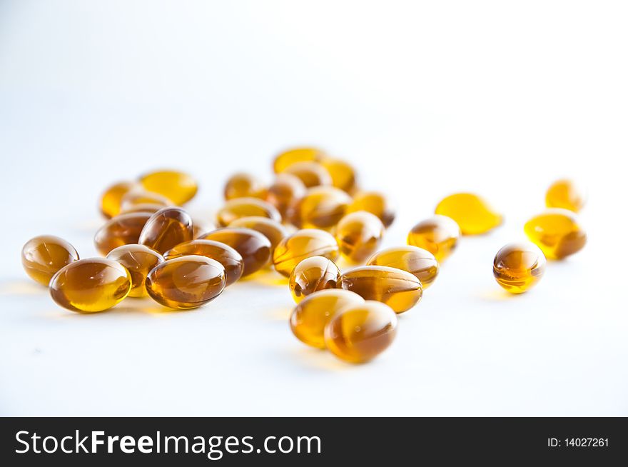 A cluster of rice oil capsules isolated against a white background. A cluster of rice oil capsules isolated against a white background