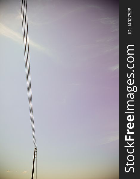 A power line on a purple background. A power line on a purple background