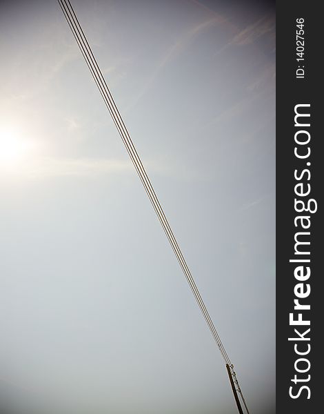 A power line on a blue sky background. A power line on a blue sky background