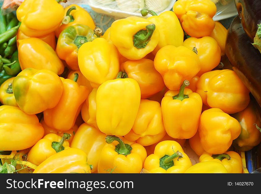 Close up of yellow sweet peppers on market stand