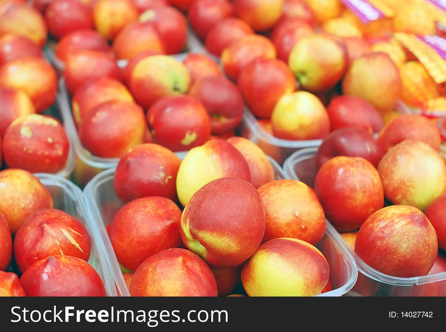 Close up of red nectarines on market stand