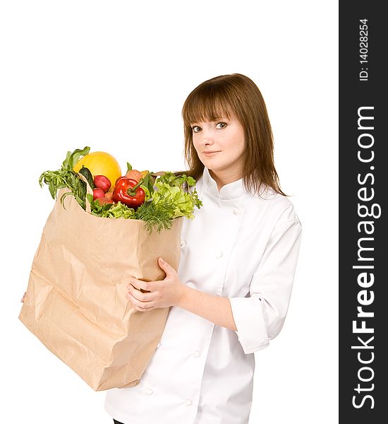 Cook girl holding a paper bag with vegetables