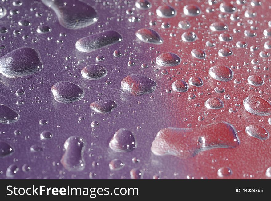 Pattern in drop of water on violet red background