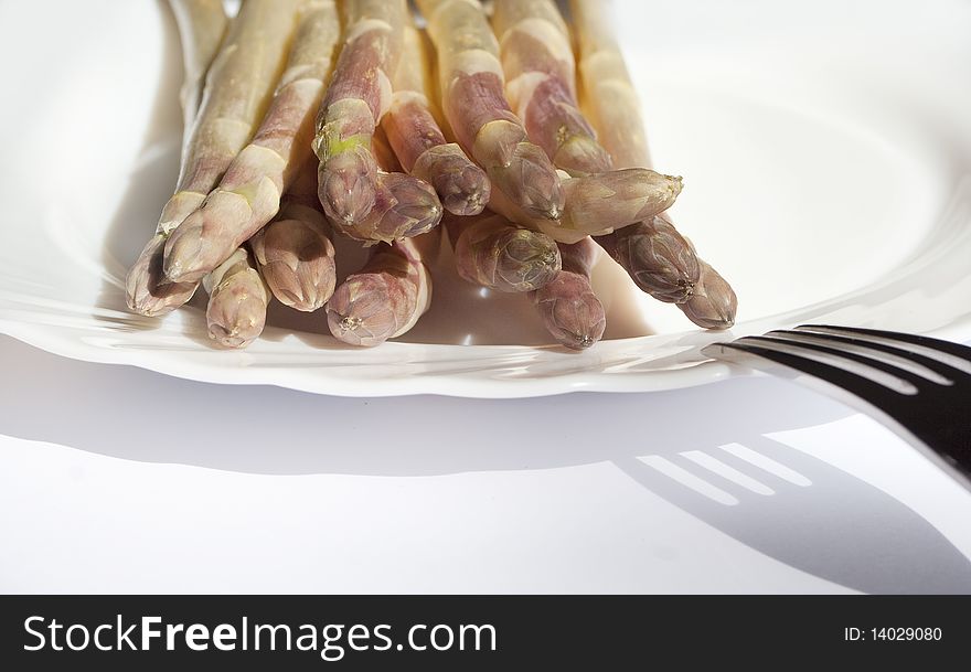 Fresh white  Asparagus on white plate with spoon