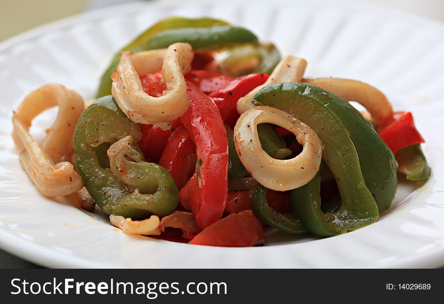 Closeup detail of a stir-fry squid rings and peppers. Closeup detail of a stir-fry squid rings and peppers