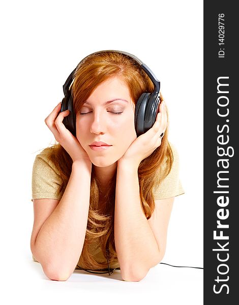 Girl with headphones laying isolated over white background