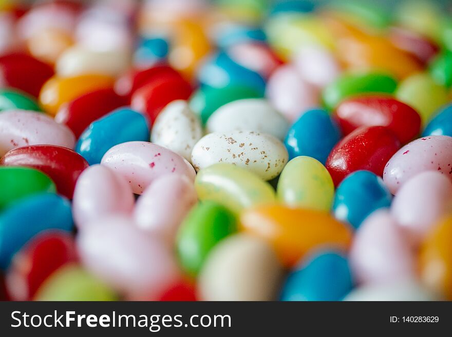 Colorful candy beans as texture and background. Close up view of jelly beans with selective focus.