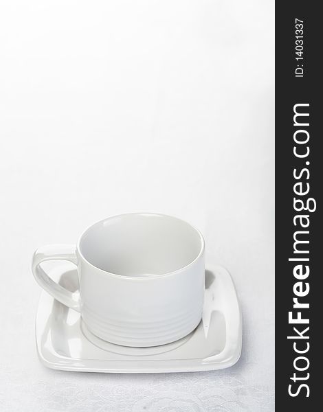 Teacup on white tablecloth