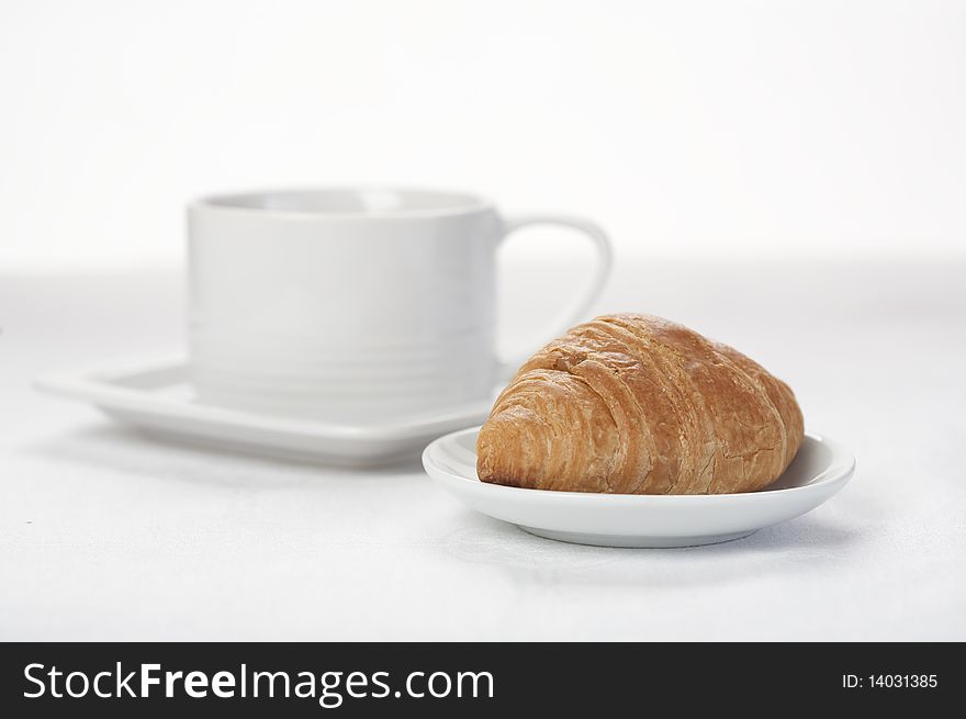 Croissant and cup of coffee/tea