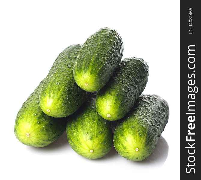 Cucumbers heaps isolated on white background. Green pyramid. Cucumbers heaps isolated on white background. Green pyramid