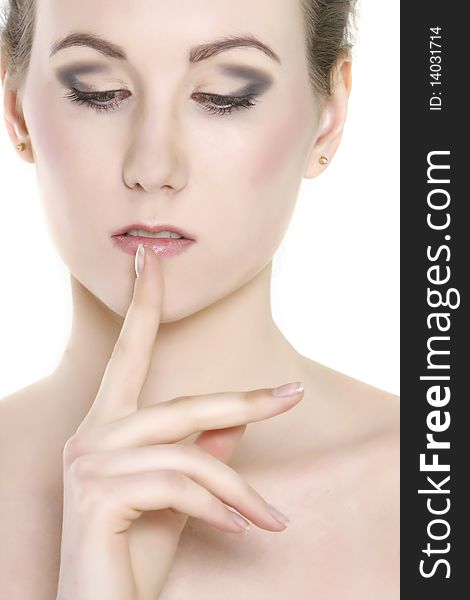 Close up of beautiful woman with finger at her lips