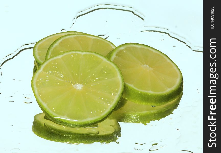 Lime in water on a blue background