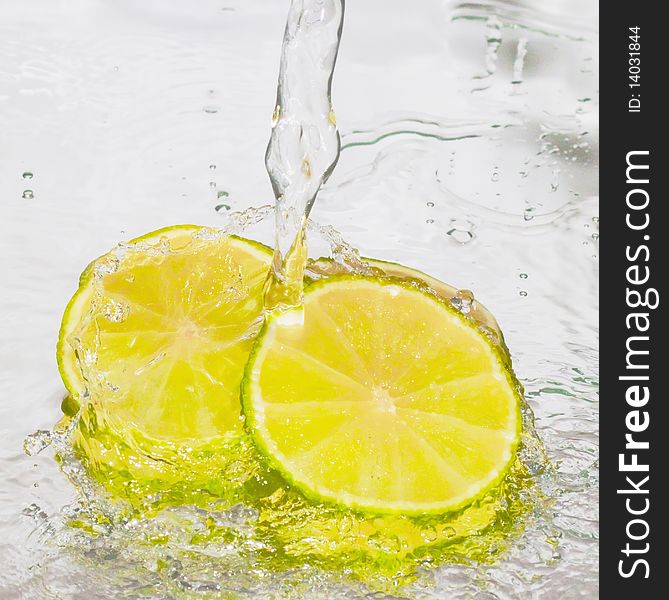 Lime in water on a blue background