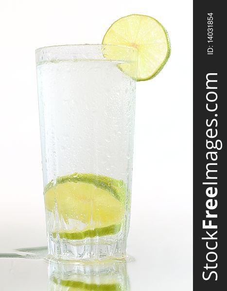 Glass of water with lime and a reflection