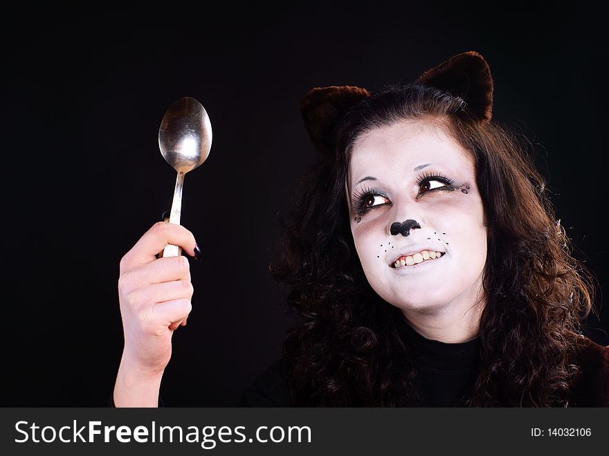 Portrait of cat-girl with spoon. Studio shot.