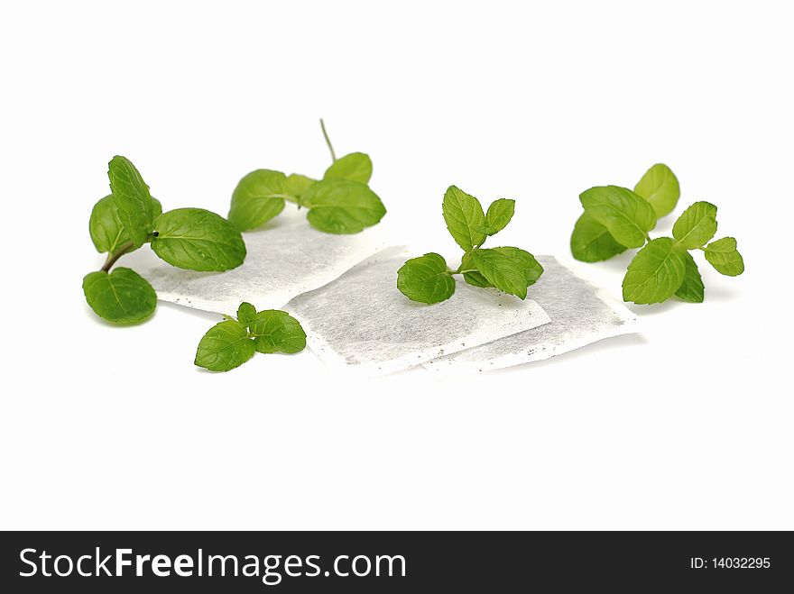 Mint tea bags and fresh mint leaves