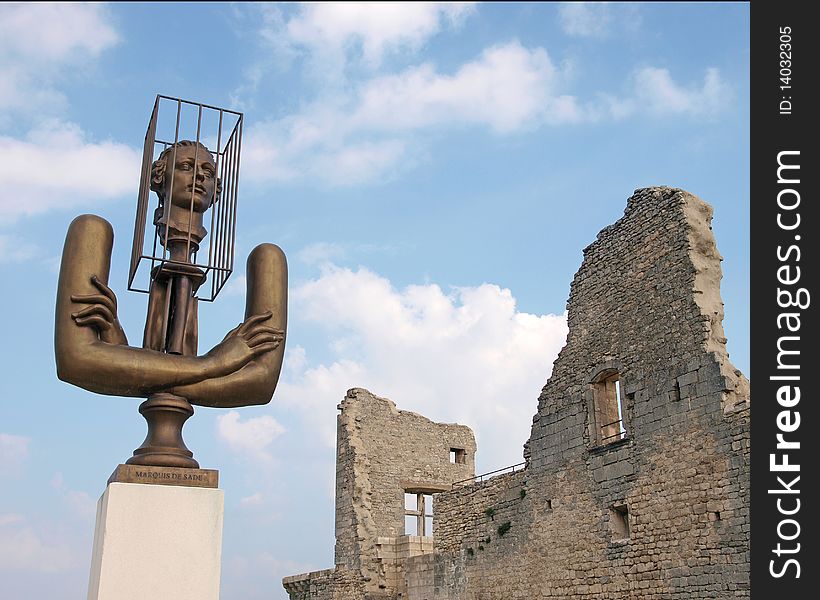 Castle ruins of Marquis de Sade and bronze of the Marquis in Lacoste, France. Castle ruins of Marquis de Sade and bronze of the Marquis in Lacoste, France