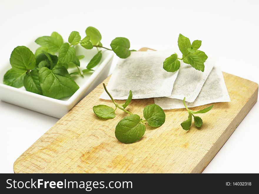 Mint tea bags and fresh mint leaves