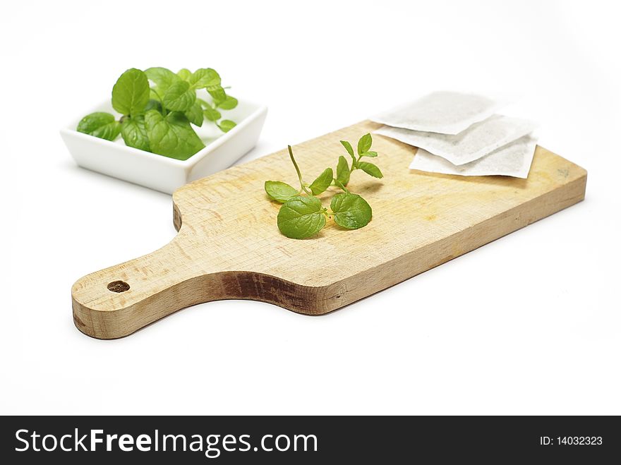 Mint tea bags and fresh mint leaves