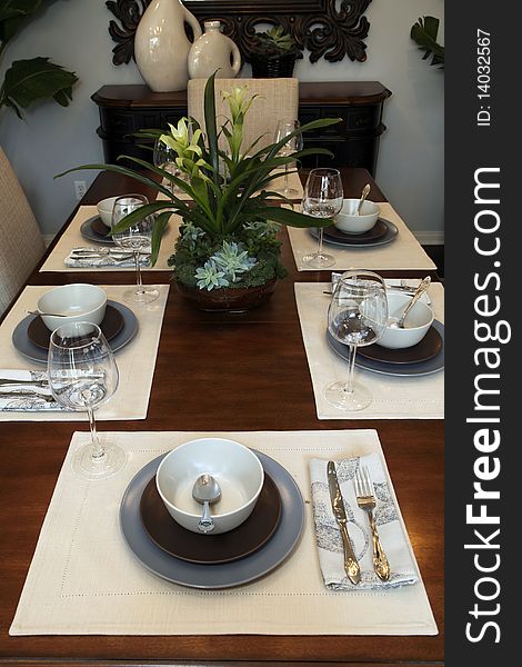 Dining table with contemporary tableware and festive decor. Dining table with contemporary tableware and festive decor.