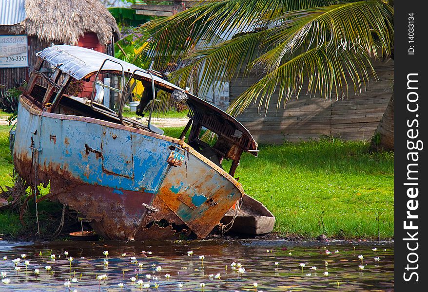 A small rusted, abandoned ferry in the town of Bomba, Belize. A small rusted, abandoned ferry in the town of Bomba, Belize