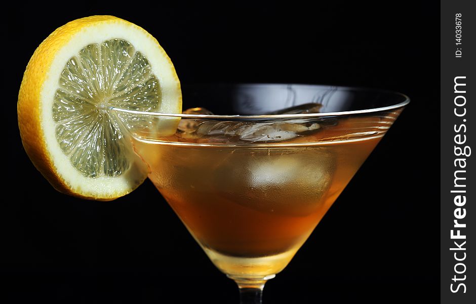 Lemon and Liqueur on the rocks, isolated on black. Lemon and Liqueur on the rocks, isolated on black