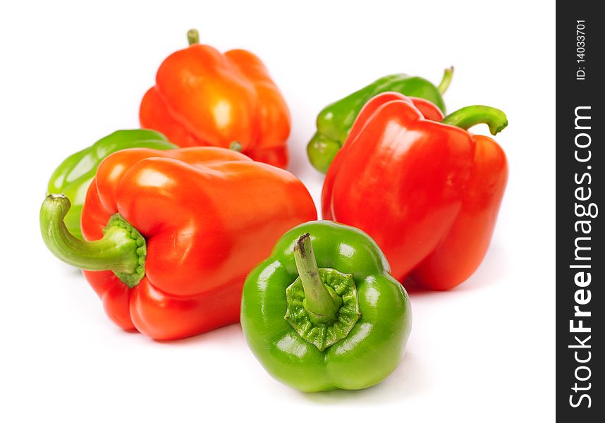 Red and green peppers on white