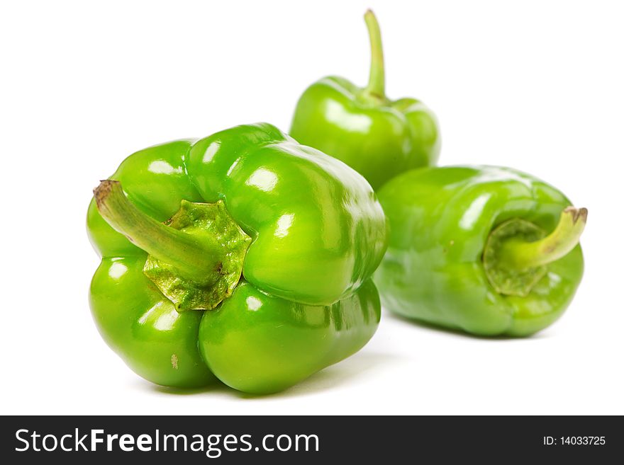 Green peppers on a white