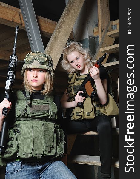Beautiful girls in military camoflage with paintball gun. Beautiful girls in military camoflage with paintball gun