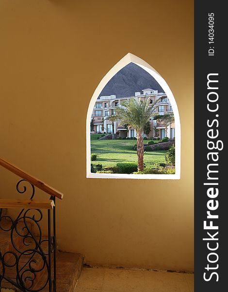 Egyptian window with palm tree and stairs