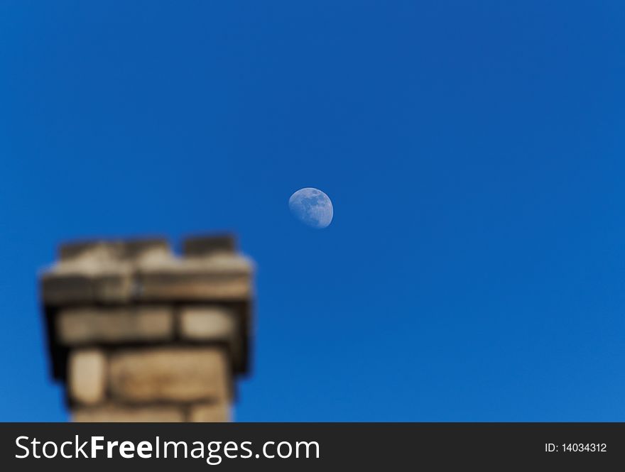 Smokestack against the blue sky with moon